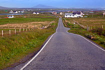 Single track road and crofters houses, Baile Mor, North Uist, Outer Hebrides, Scotland, UK, June.