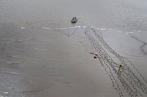 Set gill net fishing for Sockeye salmon (Oncorhynchus nerka) from the coast, Graveyard Point, Bristol Bay, Alaska, USA, July 2015.