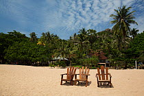 Sun loungers on beach at Tanote Bay, Koh Tao, Thailand, October 2013.