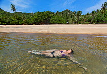 Woman swimming in  Tanote Bay, Koh Tao, Gulf of Thailand, Thailand, October 2013. Model released.
