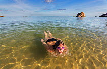 Woman swimming near the shore,  Koh Tao, Thailand, October 2013. Model released.