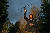 Fridolin Zimmermann, biologist at KORA, monitoring wild European lynx (Lynx lynx) with radiotracker, Jura mountains, Switzerland, March.