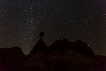Toadstool shaped hoodoo silhouetted against sky at night, Grand Staircase-Escalante National Monument, Utah, Usa, February 2015.