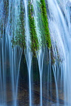 Water flowing over moss, Toberia Falls, Andoin, Sierra Entzia Natural Park, Alava, Basque Country, Spain, April.