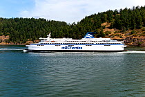 Ferry Spirit Of British Columbia passing between Galiano Island and Mayne Island in the Gulf Island Group, British Columbia, Canada, May 2015.