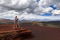 Vicky Spring taking photographs of the wilderness trail on Inferno Cone, in Craters Of The Moon National Monument, Idaho, USA 2015. July. Model released.