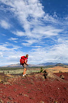 Vicky Spring hiking the wilderness trail in Craters Of The Moon National Monument, Idaho, USA, July 2015. Model released.