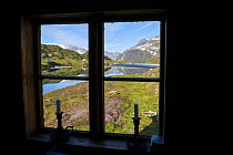Ovre Pikhaugvatnet Lake through the window of the Pikhaughytta, a small hut, Glomdalen Valley, Saltfjellet-Svartisen National Park, Norway, August 2015.