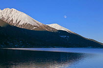 Mountain landscape reflected in lake, Basongcuo National Park, Qinghai-Tibet Plateau, Tibet,    November 2011.