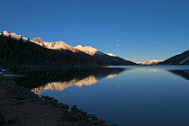 Mountains reflected in Lake Basongcuo / Pagsum Lake, Basongcuo National Park, Qinghai-Tibet Plateau, Tibet,    November 2011.