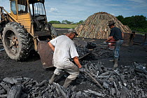 Two charcoal burners sorting charcoal, Transylvania, Romania, June 2015.