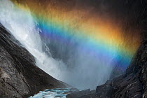 View of a rainbow in the spray of Bjornefossen Waterfall, Saltfjellet-Svartisen National Park, Norway, August 2015.