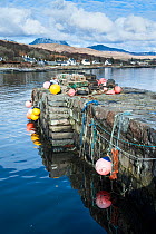 Lobster traps and buoys on pier at Craighouse, Jura, Inner Hebrides, Scotland, April 2014.