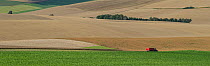 Panoramic view of fields with combine harvester in the distance in Etaples, Pas De Calais, France, July 2015.