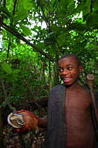 Baka child holding a Giant African land snail (Achatina sp) South East Cameroon, July 2008.