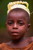 Baka boy wearing a newly made fiber crown for a night ceremony, South East Cameroon, July 2008.