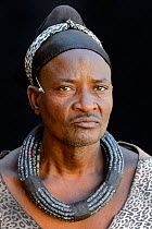 Himba man with a modern dress but wearing a typical necklace and a turban he never removes. Kaokoland, Namibia October 2015
