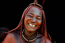 Portrait of Himba woman with the traditional hairstyle and jewellery, Kaokoland, Namibia October 2015