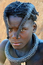 Himba girl traditional double plait hairstyle of the pre-adolescent. Kaokoland, Namibia. October 2015