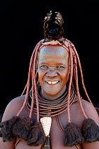 Portrait of Himba woman with traditional hair and jewellery, Kaokoland, Namibia October 2015