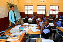 Teacher and teenagers studying in classroom at Etanga school, Kaokoland, Namibia. October 2015