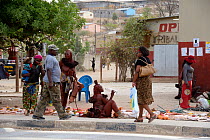 Street market with Himba women selling goods, city of Opuwo, Kaokoland, Namibia. October 2015