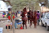 Street market with Himba women and children, city of Opuwo, Kaokoland, Namibia. October 2015