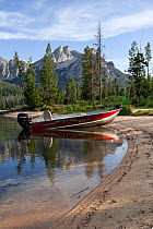 Boat beached on shore of Stanley Lake with McGowin Pear in distance, Sawtooth National Recreation Area, Idaho, USA. July 2015.