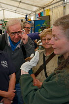 Samantha Pickering showing a Noctule bat (Nyctalus noctula) to members of the public at an outreach event, Boscastle, Cornwall, UK, October.