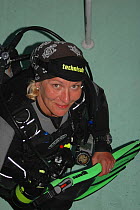 Portrait of photographer Olga Kamenskaya with camera and diving equipment. Russia, June 2005.