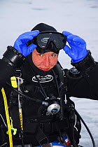 Portrait of photographer Olga Kamenskaya in diving gear, Lake Baikal, Russia, February 2008.