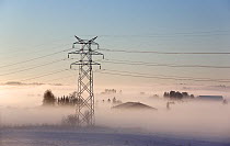 Foggy landscape with electricity pylon, Ski, Akershus, Norway, December 2014.