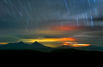 Long exposure of star trails over Virunga volcanoes seen from Bwindi Impenetrable National Park, Uganda. November