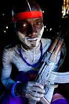 Mursi man with bodypaint,  armed with gun. Omo Valley. Ethiopia.