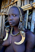 Woman in traditional headdress. Mursi tribe, Mago National Park. Omo Valley, Ethiopia.