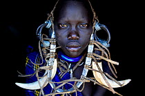 Young girl wearing traditional headdress, Mursi tribe, Mago National Park. Omo Valley, Ethiopia.
