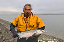 Inuit fisherman with salmon, Sewards Peninsula, Nome, Alaska, USA, September 2015.