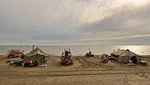 Gold dredgers and tents on beach, Sewards Peninsula, Nome, Alaska, USA, September.