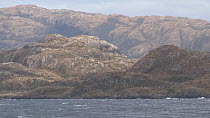 Tracking shot of a fjord landscape seen from a boat, Patagonia, Chile.