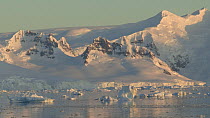 View of mountains and floating ice at sunset, Gerlache Strait, Antarctic Peninsula