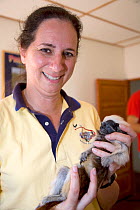 Anne Savage, director of Project / Proyecto Titi holding wild Cotton-top tamarin (Saguinus oedipus) before it's health examination, Colombia, February 2008. Critically endangered species.