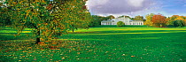 Panoramic of grassland and autumnal trees in front of Kenwood House, Hampstead Heath, London, England, UK.