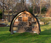 Large insect house / bug hotel in garden, Paris.