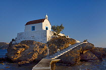 Agios Isidoros chapel, built on an islet in Gourna Bay, accessed by a wave-washed walkway, Kokkali, Leros, Dodecanese Islands, Greece, August 2013.