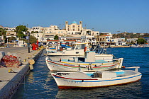 Moored fishing boats in Lipsi town harbour, with Agios Ioannis church in the background, Lipsi, Dodecanese Islands, Greece, August 2013.