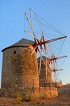 Restored windmills of the Monastery of St. John the Theologian at sunset, Chora, Patmos, Dodecanese Islands, Greece, August 2013.
