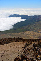 Clouds around the volcanic highlands of Tenerife, viewed from the 3718m summit of Mount Teide, with old lava flows and pumice deposits in the foreground, Tenerife, May 2014.