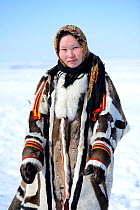 Carolina Serotetto, Nenet teenager in traditional winter coat made with reindeer skin. The collar is arctic fox fur and black beaver with felt ribbons. Yar-Sale district, Yamal, Northwest Siberia, Rus...