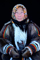 Tatiana Salinder, portrait of Nenet herder in winter coat of reindeer fur. The collar is arctic fox fur with black beaver fur and felt ribbons. Yar-Sale district, Yamal, Northwest Siberia, Russia. Apr...