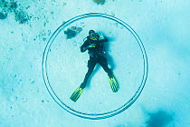 Dive instructor Ahmed Gomaa blows bubble rings whilst scuba diving at dolphin house reef, northern Red Sea, February 2016